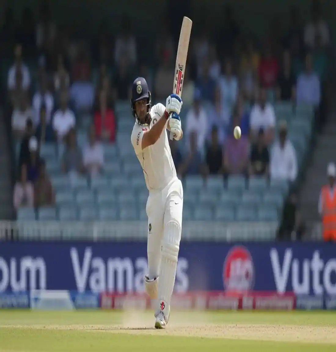 Cricket batsman playing powerful shot with ball leaving bat in dynamic action